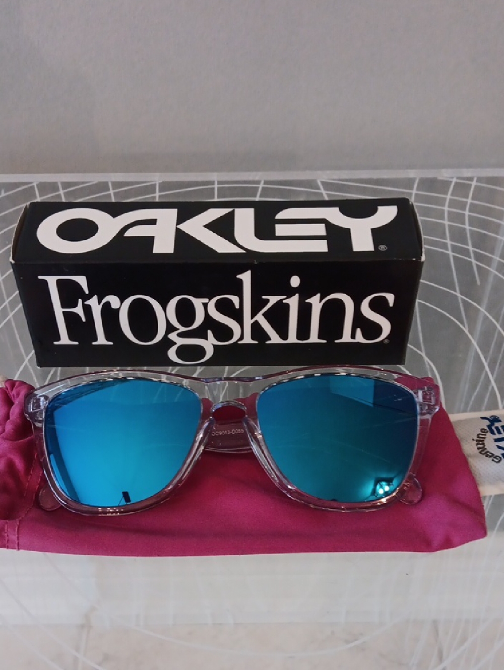Oakley Clear Frame Sunglasses with Blue Mirrored Lenses and Pink Pouch